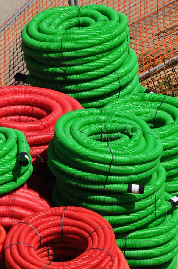 A Stack of Green and Red Underground Cable Protective Sleeves Pipes for