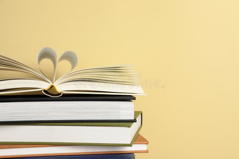 Stack of Hardcover Books on Yellow Background, Space for Text Stock