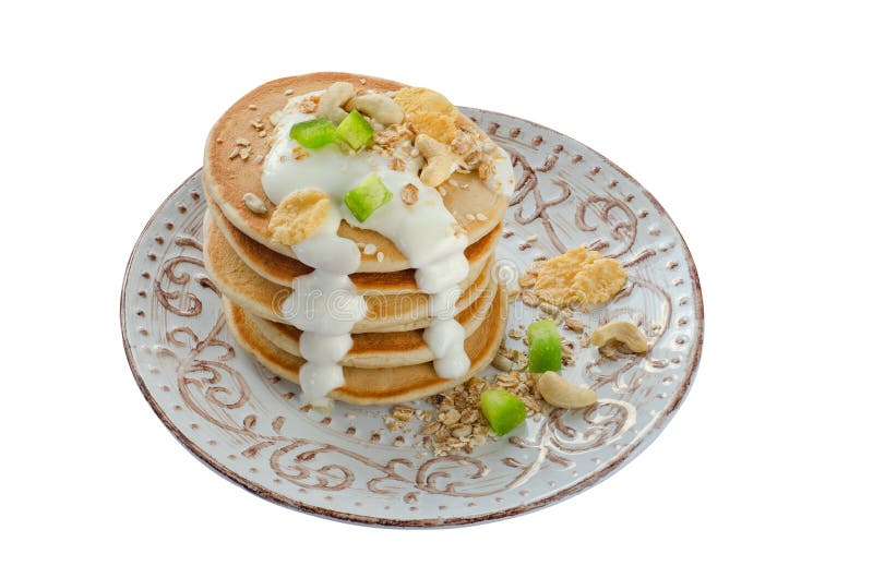 Stack of Hot Pancakes with Oatmeal and Yogurt. Isolated. Stock Photo