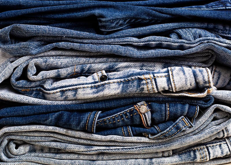 A Stack of Light and Dark Jeans Close-up. Jeans Background, Texture ...