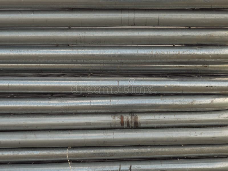 Stack of metal pipes or fences royalty free stock photography