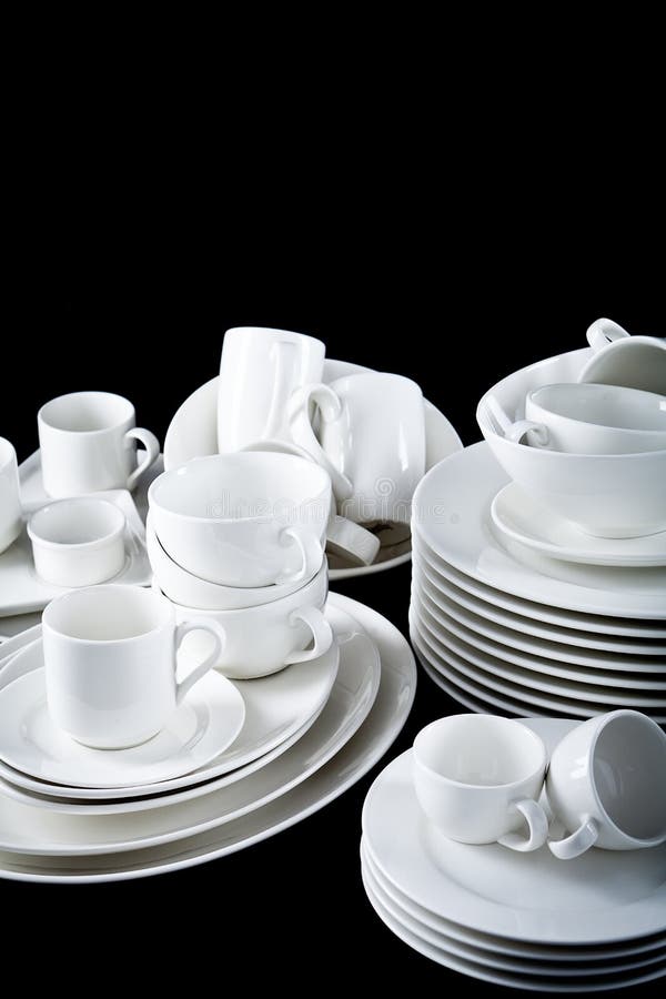 Mixed White Dishes Cups and Plates Isolated on Black Stock Photo