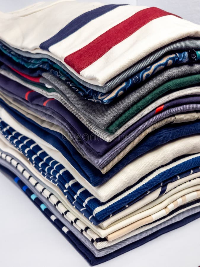 Stack of neatly folded colorful shirts ready for everyday wear royalty free stock photo