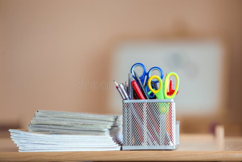Stack Of Notebooks And Stationery Arrangement In Classroom Or Office On