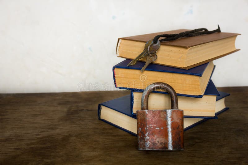 Stack of old big books and lock