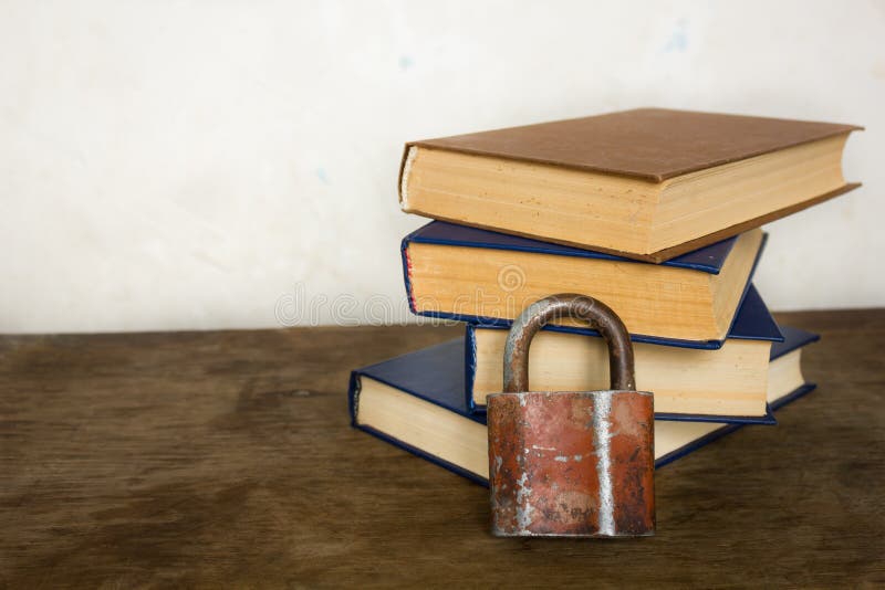 Stack of old big books and lock