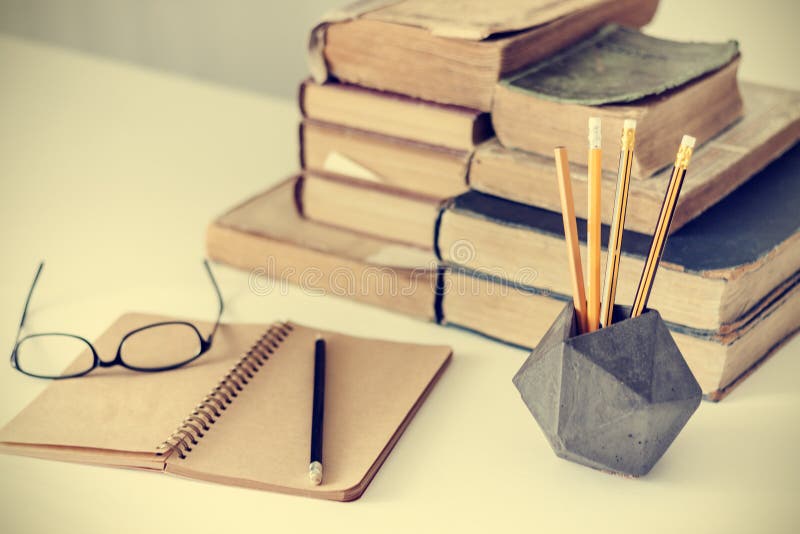 Stack of old books, textbook, glasses and pencils in office background for education retro concept royalty free stock image Stack of old books, textbook, glasses and pencils in office background for education retro concept royalty free stock image