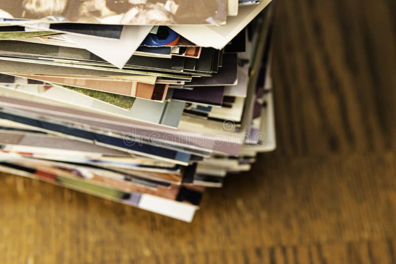 Stack of old photo prints and Memories to be digitized a