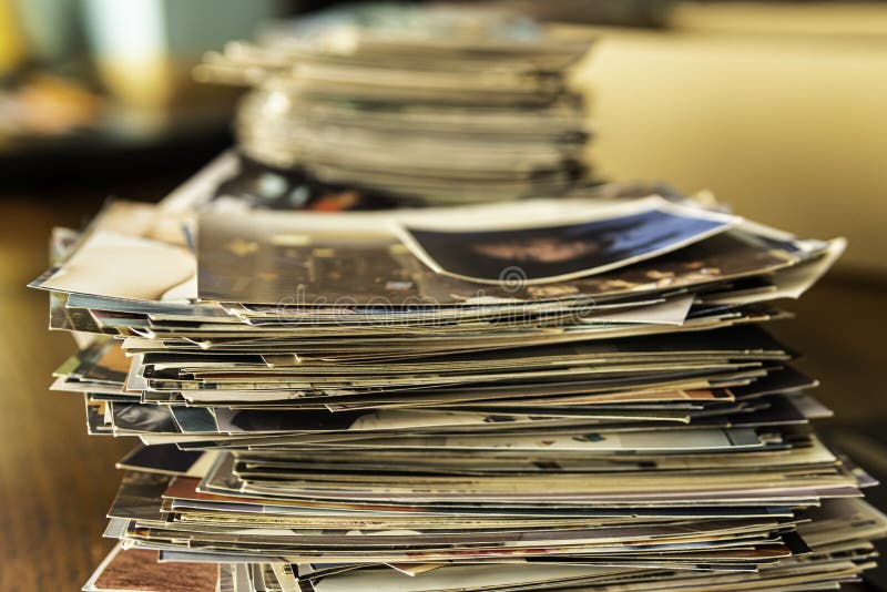 Stack of old photo prints and Memories to be digitized a