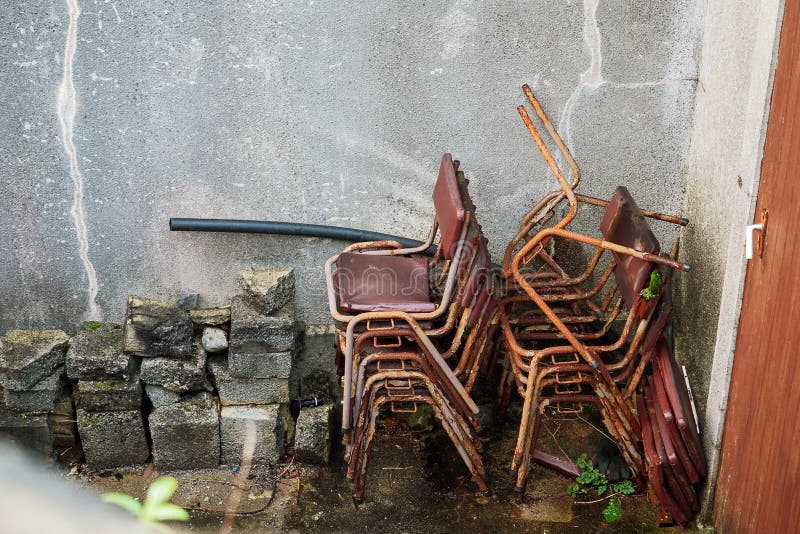 Stack of old rusty metal frames in a back yard of a school royalty free stock images