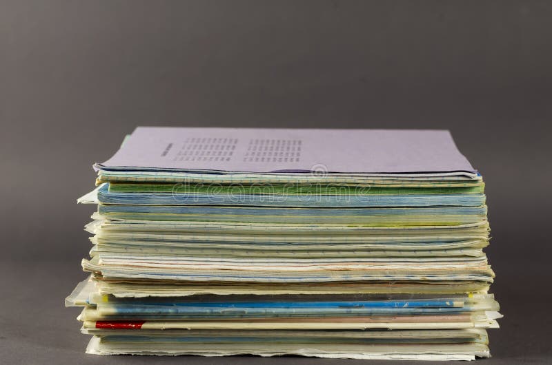 Stack of Old School Exercise Books on a Gray Background Stock Photo