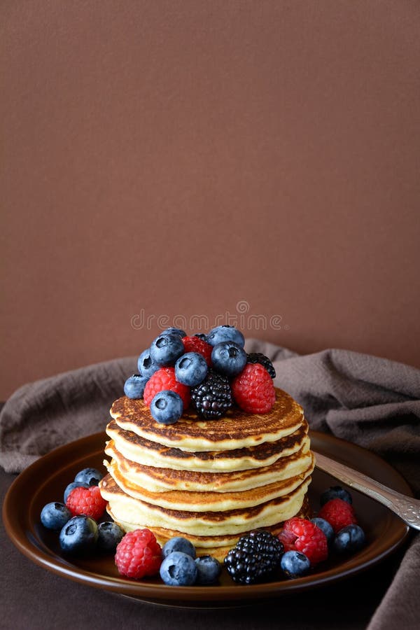 Stack of Pancakes with Fresh Blueberry, Raspberry and Blackberry on