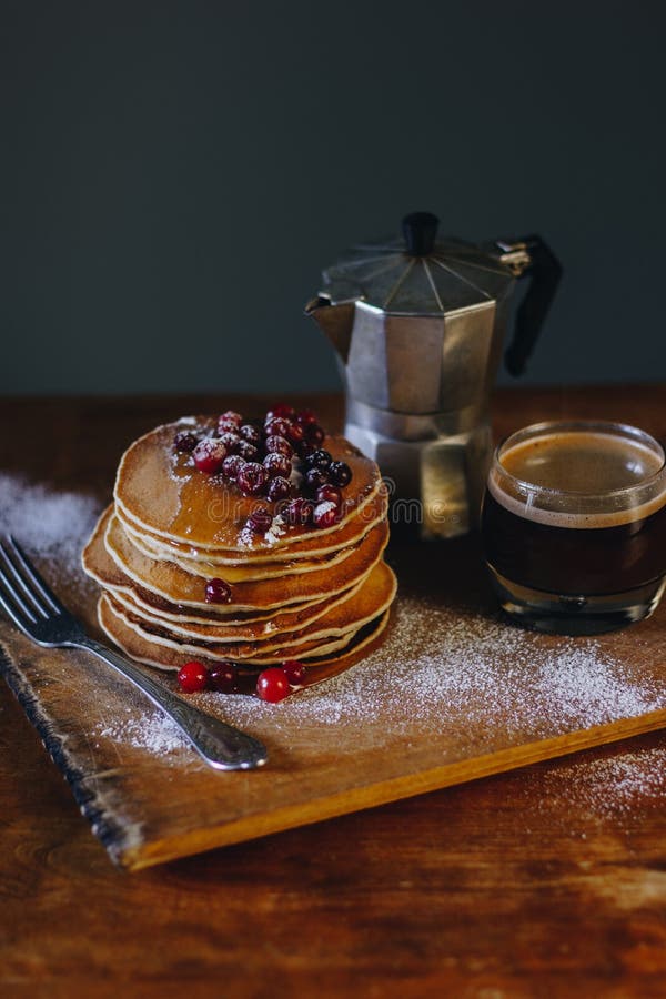 Stack of Pancakes with Maple Syrup and Cranberries and Coffee Stock