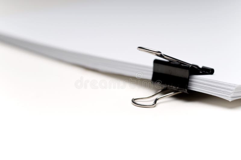 Stack of paper held with a clip royalty free stock images