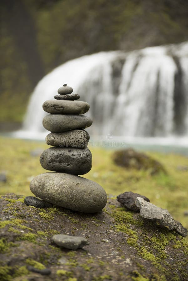 Stack of pebbles and waterfall