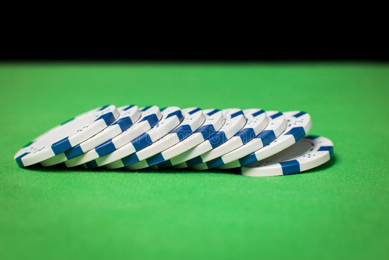 Stack of poker chips on a green table