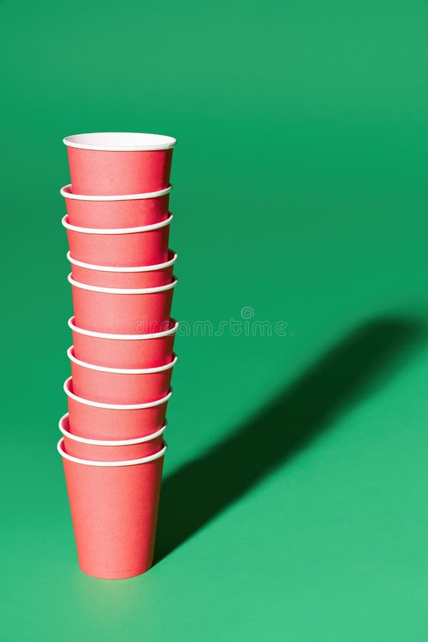 Closeup shot of stacks of red and green plastic cups isolated on a