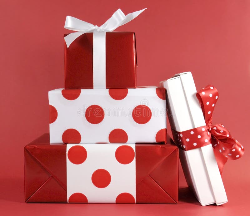 Stack of red and white polka dot theme festive gift box presents