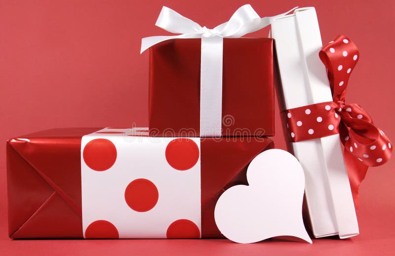 Stack of red and white polka dot theme festive gift box presents with white heart stock photography Stack of red and white polka dot theme festive gift box presents with white heart stock photography