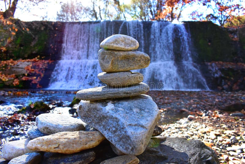 Stack of Rocks in Front of a Waterfall Stock Photo Image of water