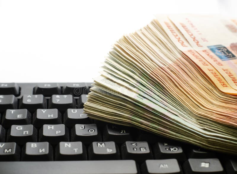 A Stack of Russian Rubles of Different Denominations Lies on the Laptop