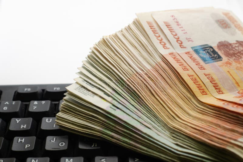 A Stack of Russian Rubles of Different Denominations Lies on the Laptop
