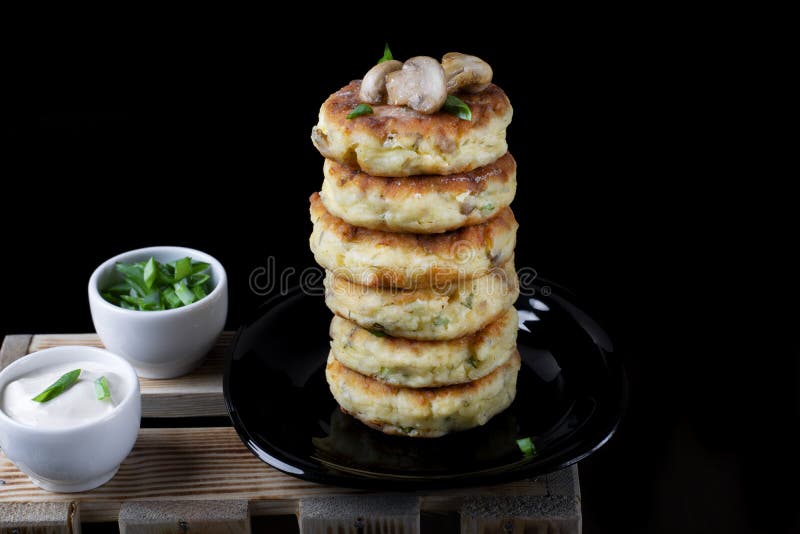 Stack of salty syrniki with champignons and herbs royalty free stock photos