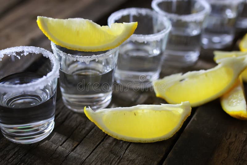 Stack of Tequila with Salt and Lemon on a Wooden Background Stock Photo ...