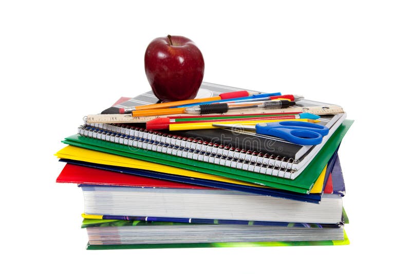 Stack of textbooks with school supplies on top