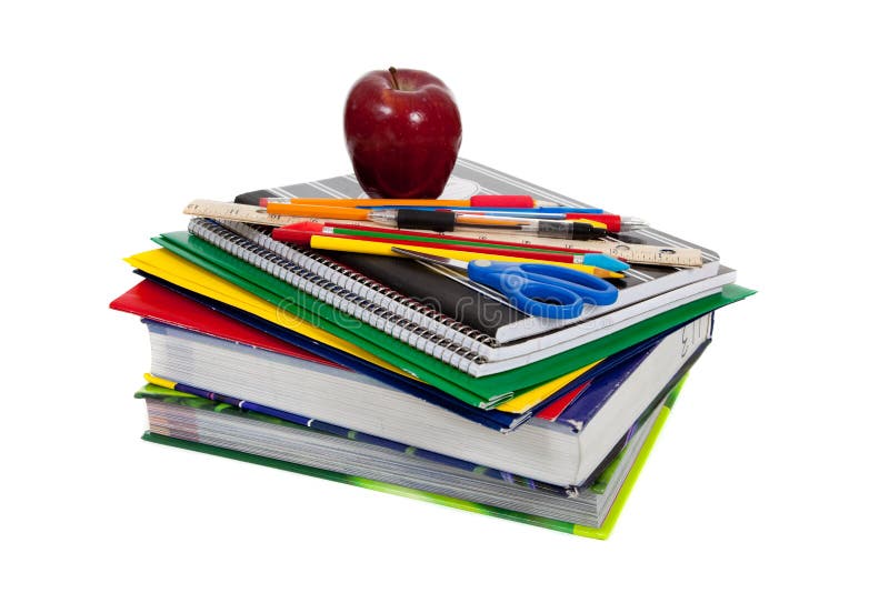 Stack of textbooks with school supplies on top