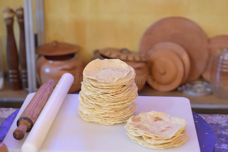 A stack of tortillas on a cutting board in a traditional mexican kitchen stock images
