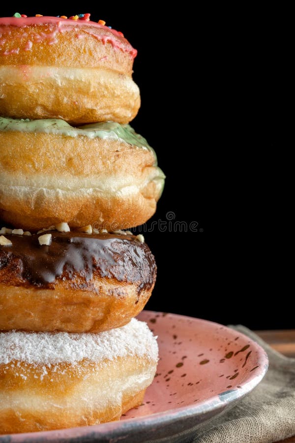 A Stack of Two Donuts on Black Background. Stock Photo Image of