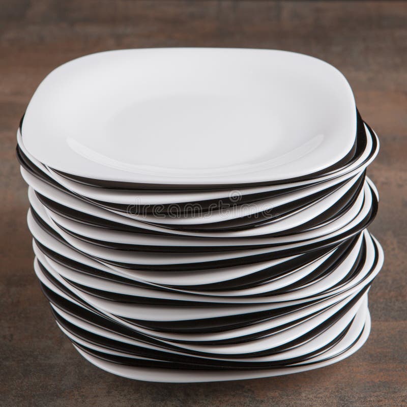 Stack of White and Black Plates on the Table, a Lot of Plates, Concept