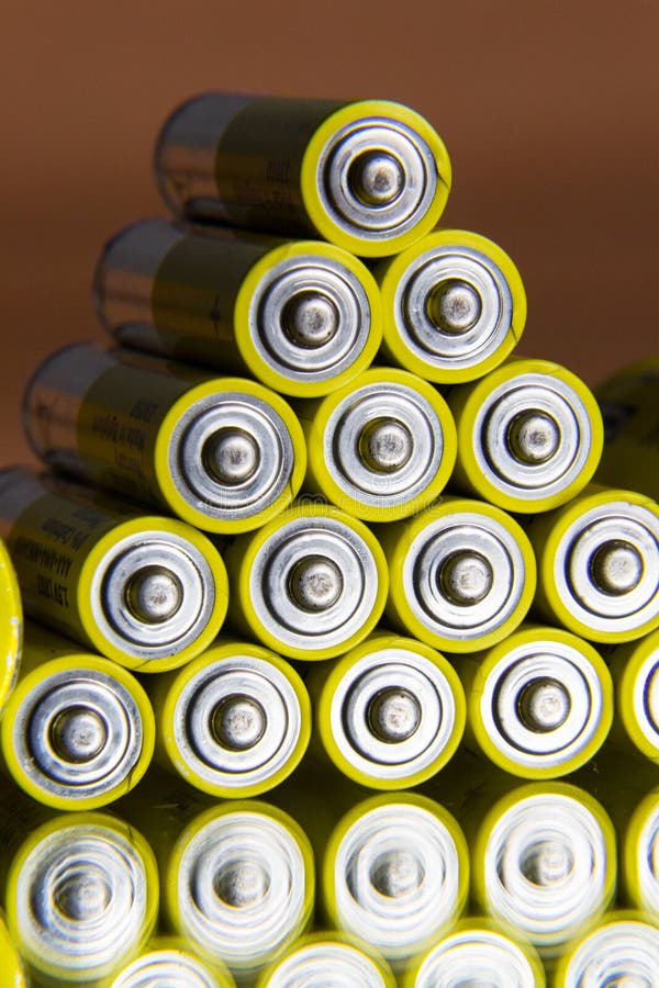 Stack of Yellow AA Batteries Close Up, Electricity Storage Concept