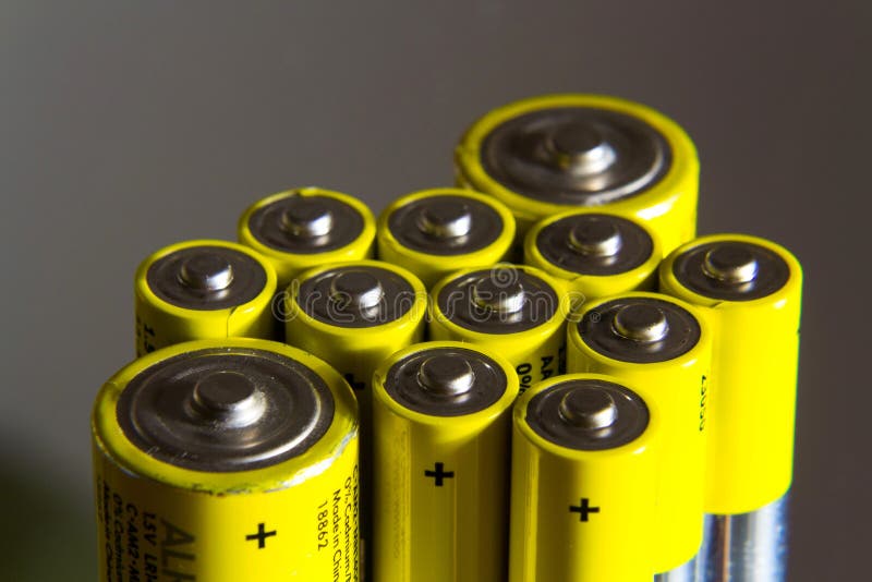 Stack Of Yellow AA Batteries Close Up, Electricity Storage Concept
