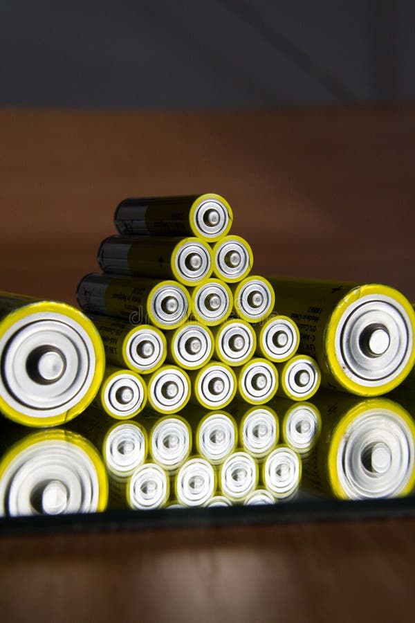Stack of Yellow AA Batteries Close Up, Electricity Storage Concept