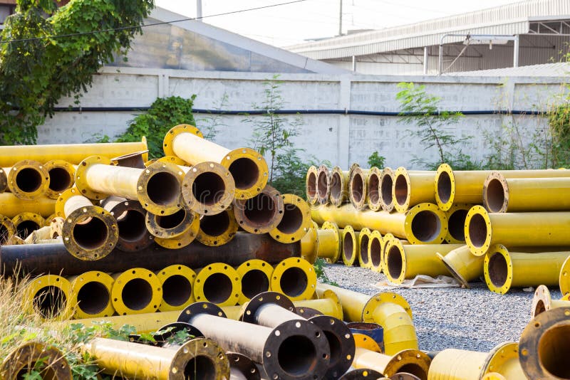 Stack of yellow steel pipe stock image. Image of metal 24557431