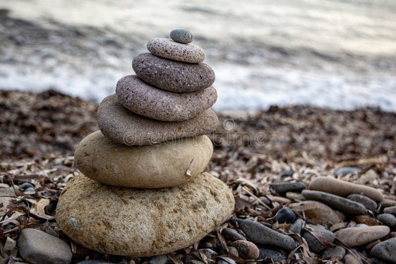 Stack of zen stones on the beach. Zen and harmony concept. Pyramid of pebbles on the beach at sunset. royalty free stock image