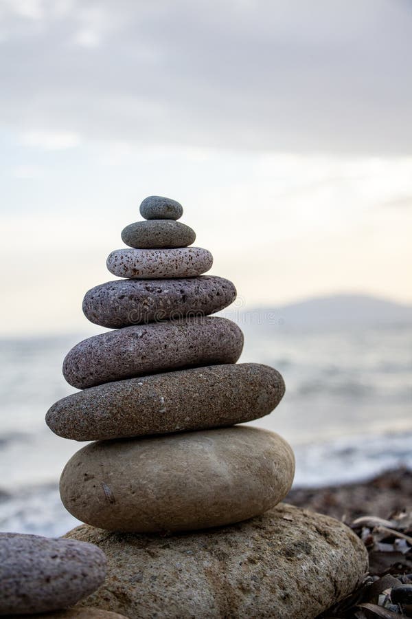 Stack of zen stones on the beach. Zen and harmony concept. Pyramid of pebbles on the beach at sunset. stock photography