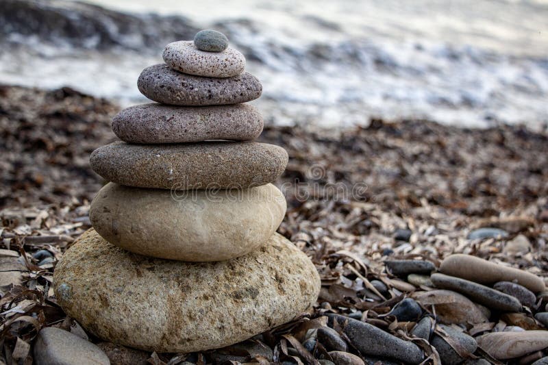 Stack of zen stones on the beach. Zen and harmony concept. Pyramid of pebbles on the beach at sunset. royalty free stock images