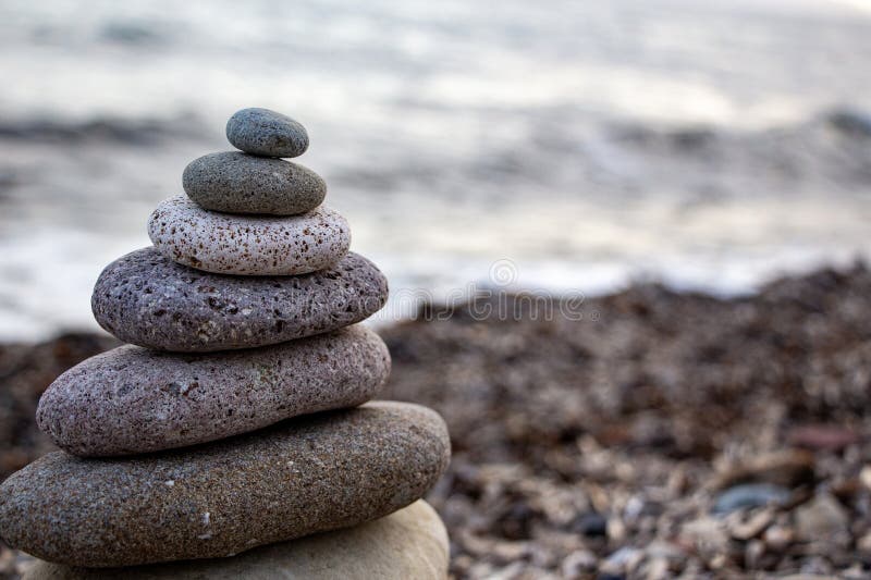 Stack of zen stones on the beach. Zen and harmony concept. Pyramid of pebbles on the beach at sunset. royalty free stock photos