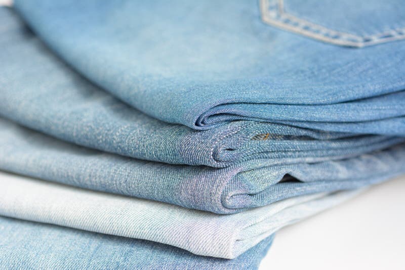 Stacked Blue Jeans on White Background Stock Image Image of cotton