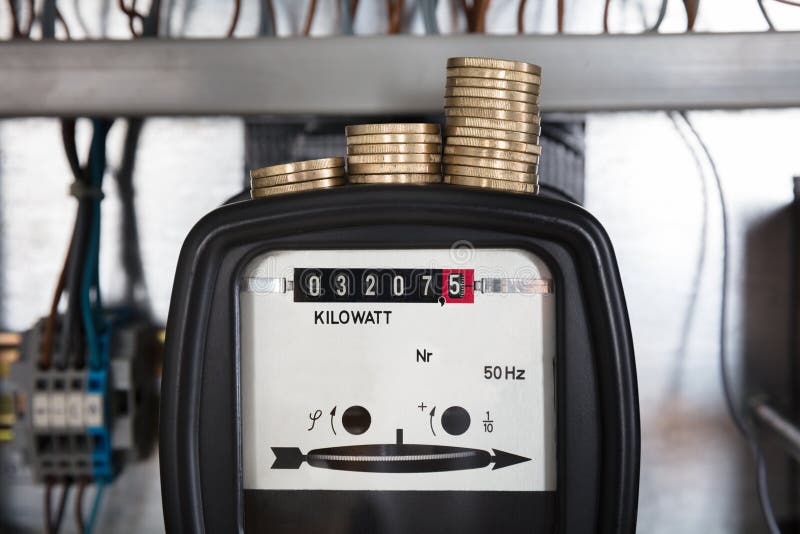 Stacked Coin On Kilowatt Meter