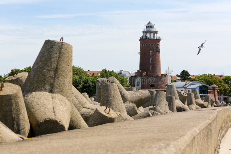 Stacked huge concrete blocks and lighthouse stock photos Stacked huge concrete blocks and lighthouse stock photos