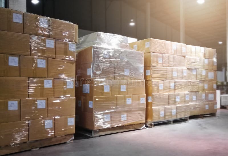 Stacked of Package Boxes Wrapped Plastic Flim on pallets at Storage Warehouse. Shipping Warehouse Logistics.