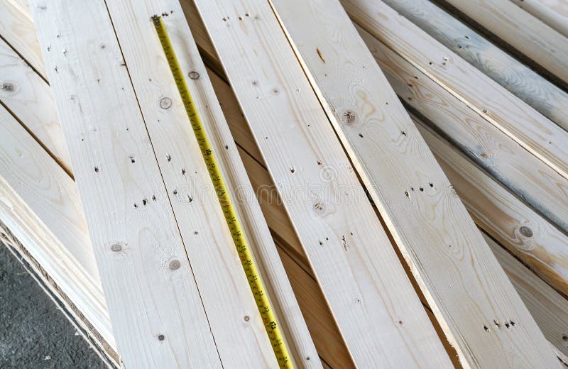 Stacked Pine Wood With A Measurement Tape On Top Wood Processing