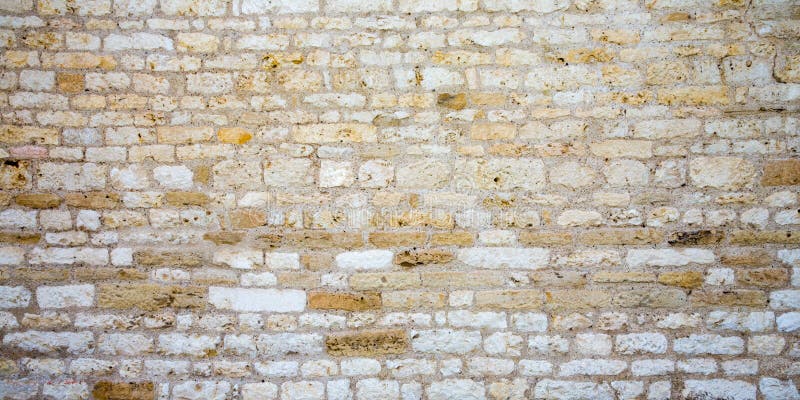 Stacked stone wall texture Medieval Background of stone wall masonry stock photo
