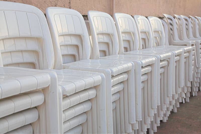 Stacked white chairs