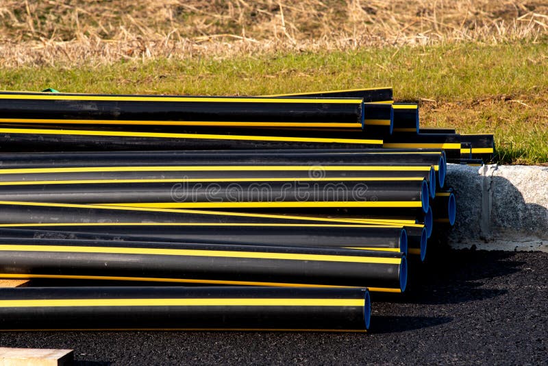 Stacks of Black Pvc Plastic Pipe Outdoors Outside the Warehouse Stock