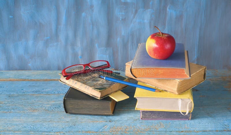 Stacks of books, apple, spectacles and pen, reading, education, back to school concept, royalty free stock photography Stacks of books, apple, spectacles and pen, reading, education, back to school concept, royalty free stock photography